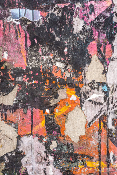 Peeling paper layers Close-up texture background image of many layers of wheatpasted paper peeling off a concrete surface. construction material torn run down concrete stock pictures, royalty-free photos & images