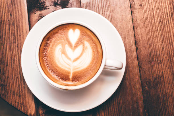 istock Coffee latte art on wooden table in coffee shop 912367370
