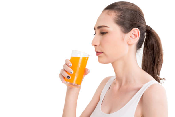istock Woman holding orange juice isolated on white background 912367408