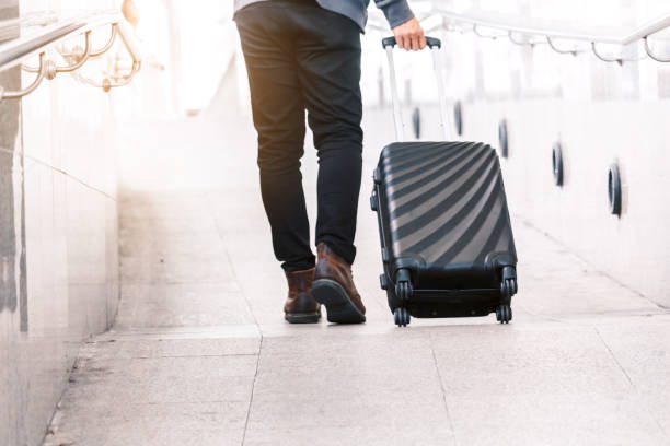 istock Business people walking with luggage 912371980