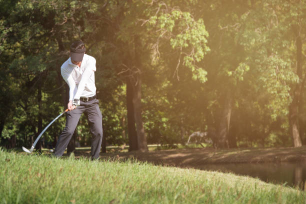 istock Asian man golf player swinging driver golf club on golf course. 912373674