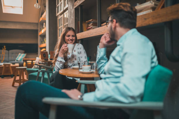 istock Beautiful couple enjoying a drink in the coffee bar 912374412