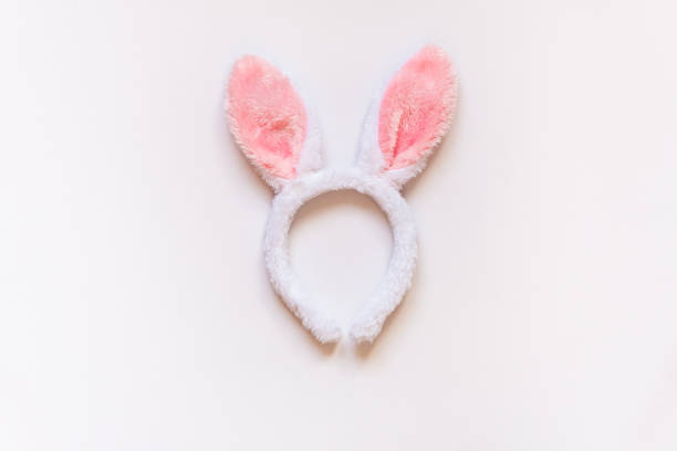 istock Top view of white fluffy bunny ears over white background. 912374598