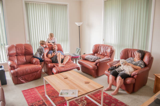 istock Family using living room with two small pet dogs 912374666