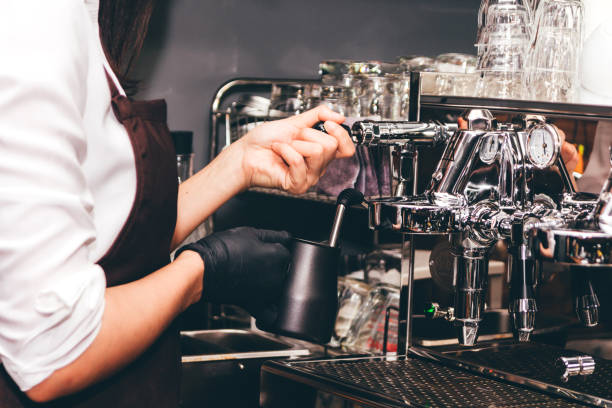 istock Women Barista using coffee machine for making coffee in the cafe 912379454