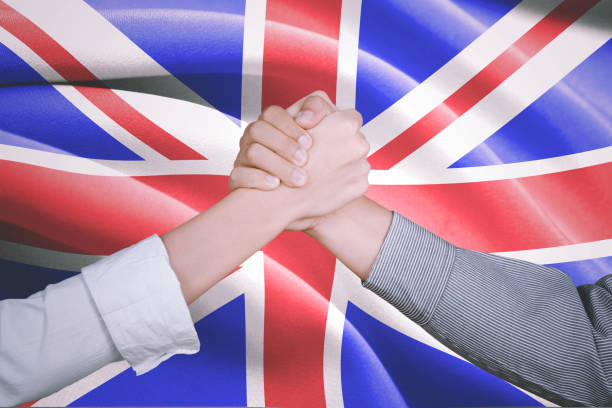 istock Hands of business people with England flag 912381966
