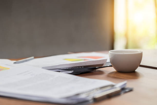 istock White Coffee cup on work table with sale report 912382052