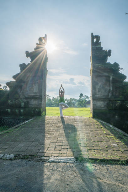 istock Female exercising yoga, Bali gate, Indonesia 912385268