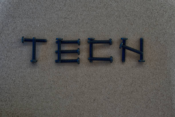 istock The word TECH by screws on a black-gray background. 912385272