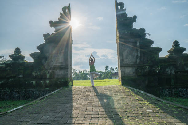 istock Female exercising yoga, Bali gate, Indonesia 912385510