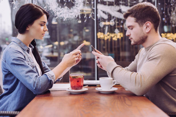 istock Focused meditative couple looking at phones 912394180