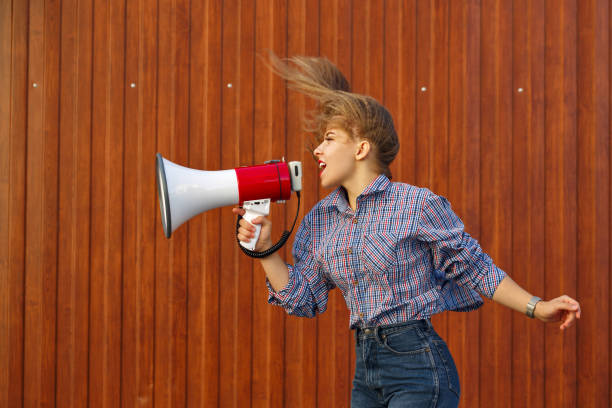 istock Girl screams into loudspeaker 912397060