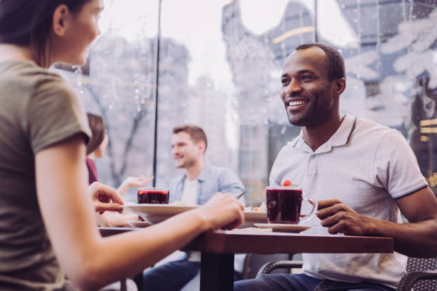 istock Charming young couple sitting at cafe 912400272