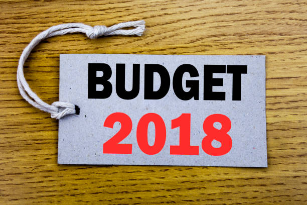 istock Conceptual hand writing text caption showing Budget 2018. Business concept for Household budgeting accounting planning written on price tag paper with copy space on the wooden vintage background 912400822