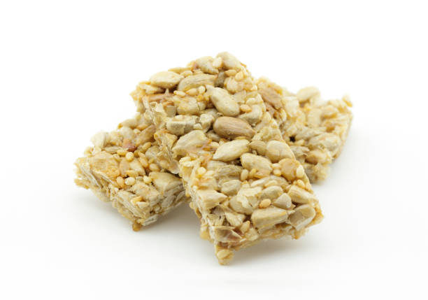 istock Sunflower seeds with sesame bar on white background 912402048