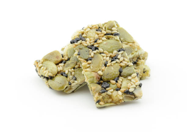 istock Pumpkin kernels with sesame bar on white background 912402052