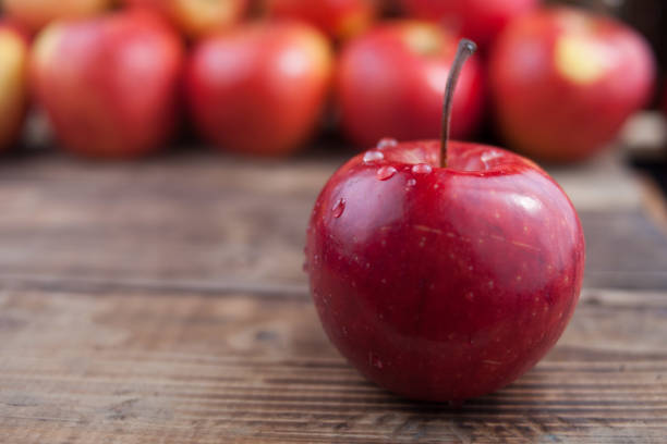 istock Red apples on a dark wooden table 912409874