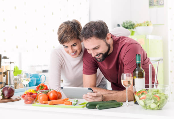 istock Couple cooking together and using a tablet 912412530