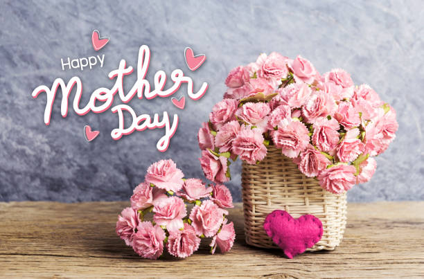 happy mothers day concept of pink paper carnation flowers in weave basket with red heart on old wood - flower head bouquet built structure carnation imagens e fotografias de stock