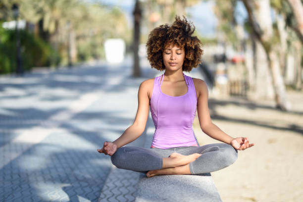 Black Woman Afro Hairstyle In Lotus Asana With Eyes Closed In The Beach  Stock Photo - Download Image Now - iStock