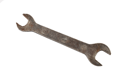 Old rusty wrench, isolated on white background