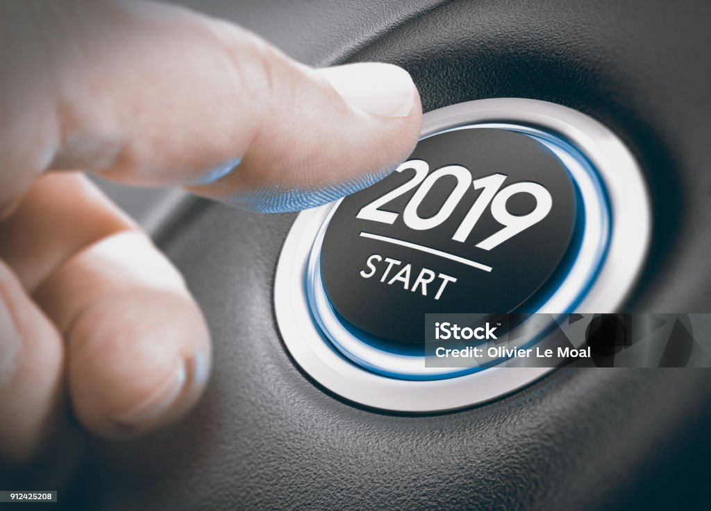 2019 Start, Two Thousand Nineteen. Finger pressing a 2019 start button. Concept of new year, two thousand nineteen. Composite between a photography and a 3D background Beginnings Stock Photo