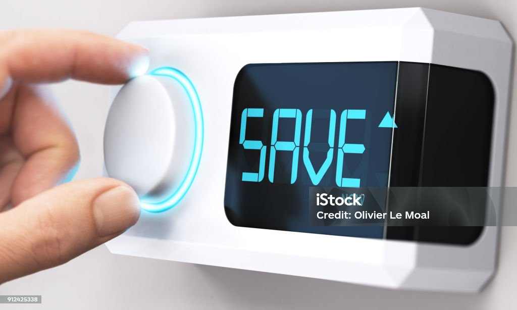 Saving Money; Decrease Energy Consumption Hand turning a thermostat knob to increase savings by decreasing energy consumption. Composite image between a hand photography and a 3D background. Energy Efficient Stock Photo