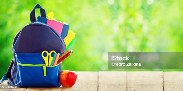 Banner Full School Backpack With Apple On Wooden And Nature Green Background Stock Photo - Download Image Now