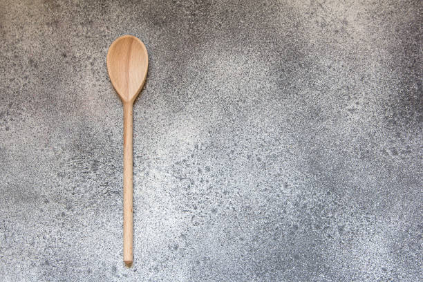 istock Wooden kitchen spoon on gray concrete style. 912430486