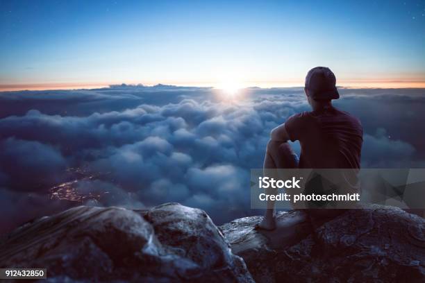 Young Man With View Over The Clouds Stock Photo - Download Image Now - People, Mountain, Cloudscape
