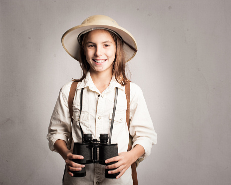 little explorer holding binoculars