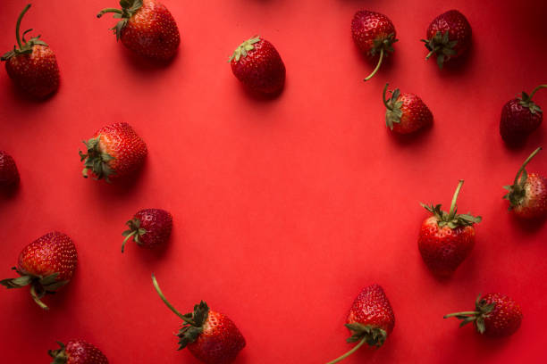 istock Heart and strawberry on a red Valentine's background 912435108