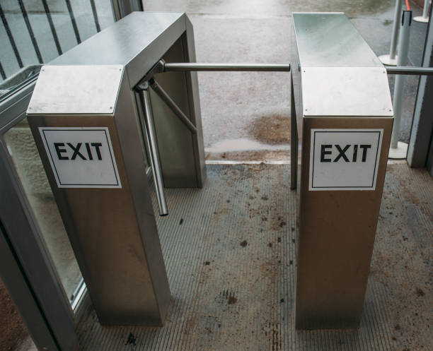 istock Metal Turnstile with inscription EXIT or urban Checkpoint close-up 912435114