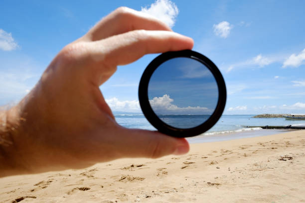 istock polarizing filter hold against the beach giving clarity. 912435212