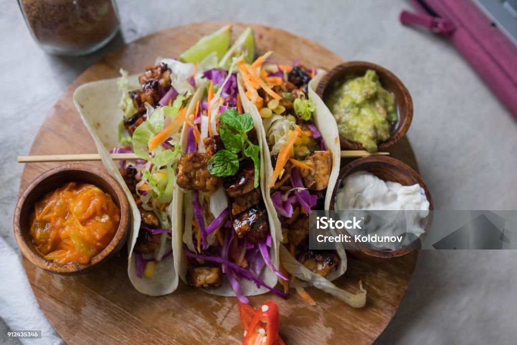 Healthy vegan salad tortilla wraps with tofu and vegetables for dinner. Healthy vegan salad tortilla wraps with tofu and vegetables for dinner. Organic raw food concept. Vegan Food Stock Photo