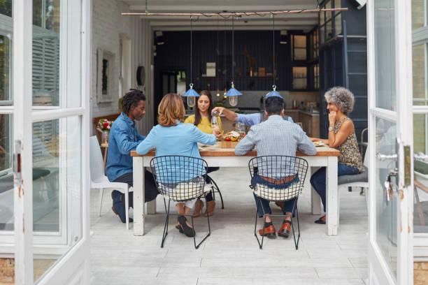 istock Multi-ethnic friends enjoying lunch at home 912437564