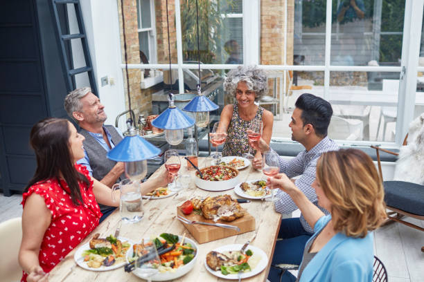 istock Happy multi-ethnic friends toasting wine at party 912438108