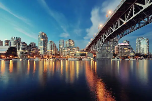 Vancouver False Creek at night with bridge and boat.