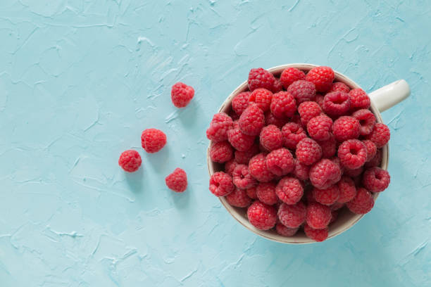 istock Raspberries in bowl, top view 912440950