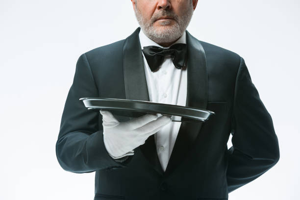 istock Senior waiter holding tray 912441114
