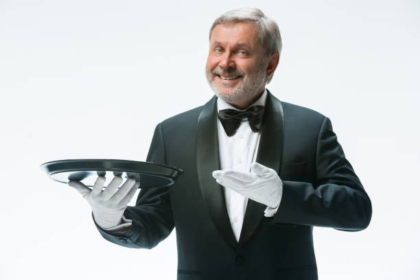 istock Senior waiter holding tray 912441300