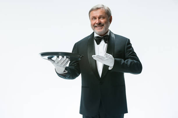 istock Senior waiter holding tray 912441320