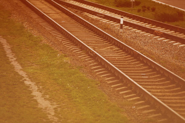 two railways tracks merge close up - connection merger road togetherness imagens e fotografias de stock