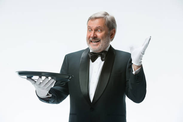 istock Senior waiter holding tray 912441664