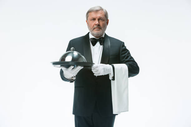 istock Senior waiter holding tray 912441826