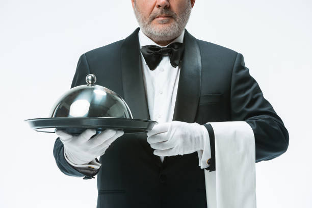 istock Senior waiter holding tray 912441890