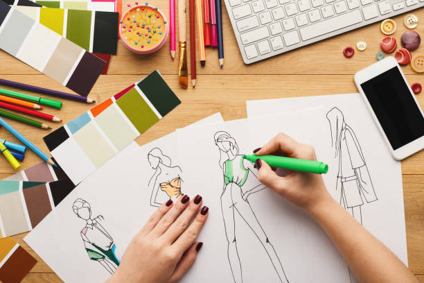istock Top view on woman designer drawing clothes sketches 912443146