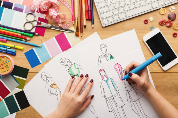 istock Top view on woman designer drawing clothes sketches 912443204