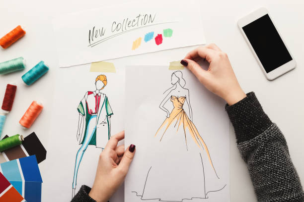 istock Top view on woman designer drawing clothes sketches 912443504