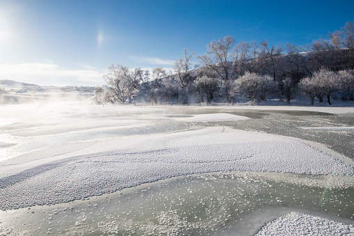 Water and snow on a flooded meadow in the foggy day, Czulczyce, Poland